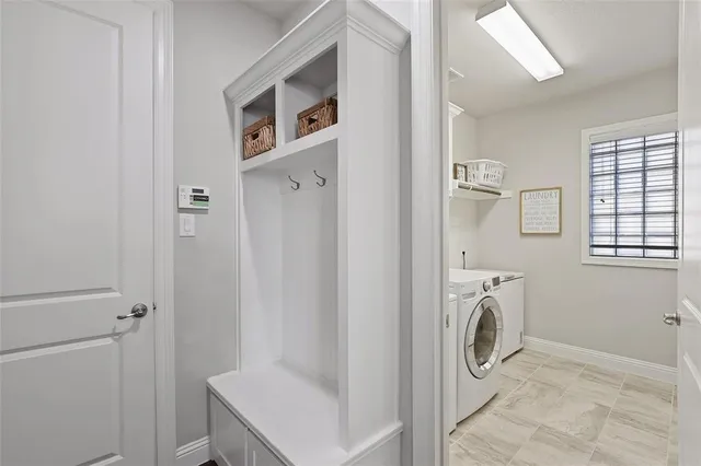 a spacious bathroom with double vanity sinks a mirror and a bathtub