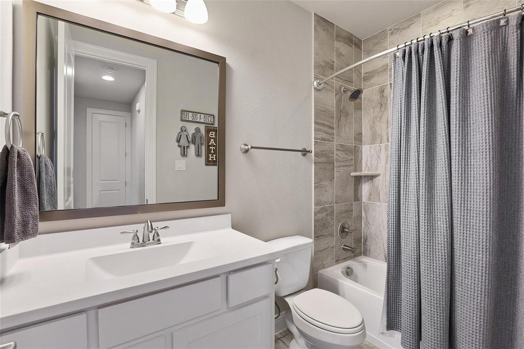 1111 Belknap Way Prosper, TX 75078 - Photo 16 of 24 Bathroom with shower / bathtub combination with curtain, a textured wall, and vanity