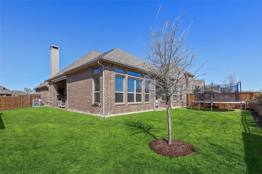 1111 Belknap Way Prosper, TX 75078 - Photo 19 of 24 Rear view of house with brick siding, a fenced backyard, and a chimney