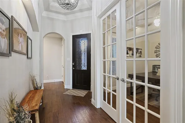 a view of a livingroom with wooden floor and a large window
