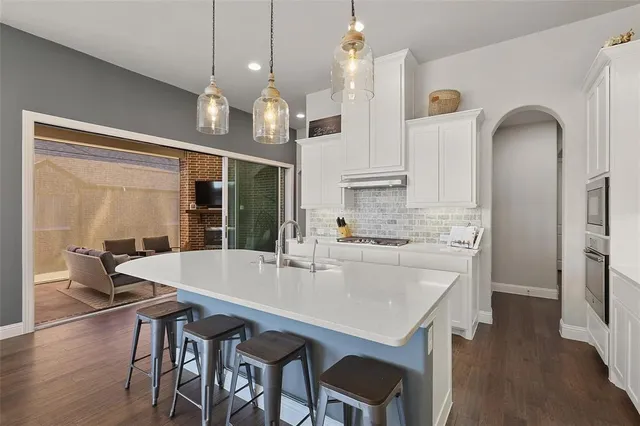 a large kitchen with a table and chairs