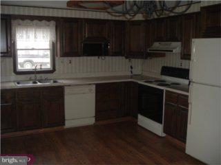 43 Highbridge Road New Egypt, NJ 08533 - Photo 3 of 6 a kitchen with kitchen island granite countertop a sink cabinets and stainless steel appliances