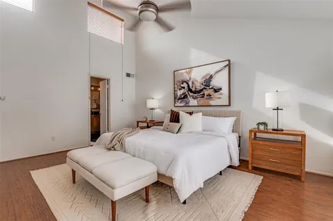 a bedroom with beds and a painting on the wall