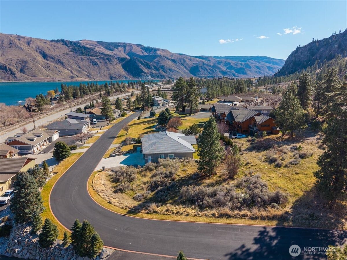 15315 Lakeview Street Entiat, WA 98822 - Photo 19 of 35 a view of a swimming pool with a yard and mountain view