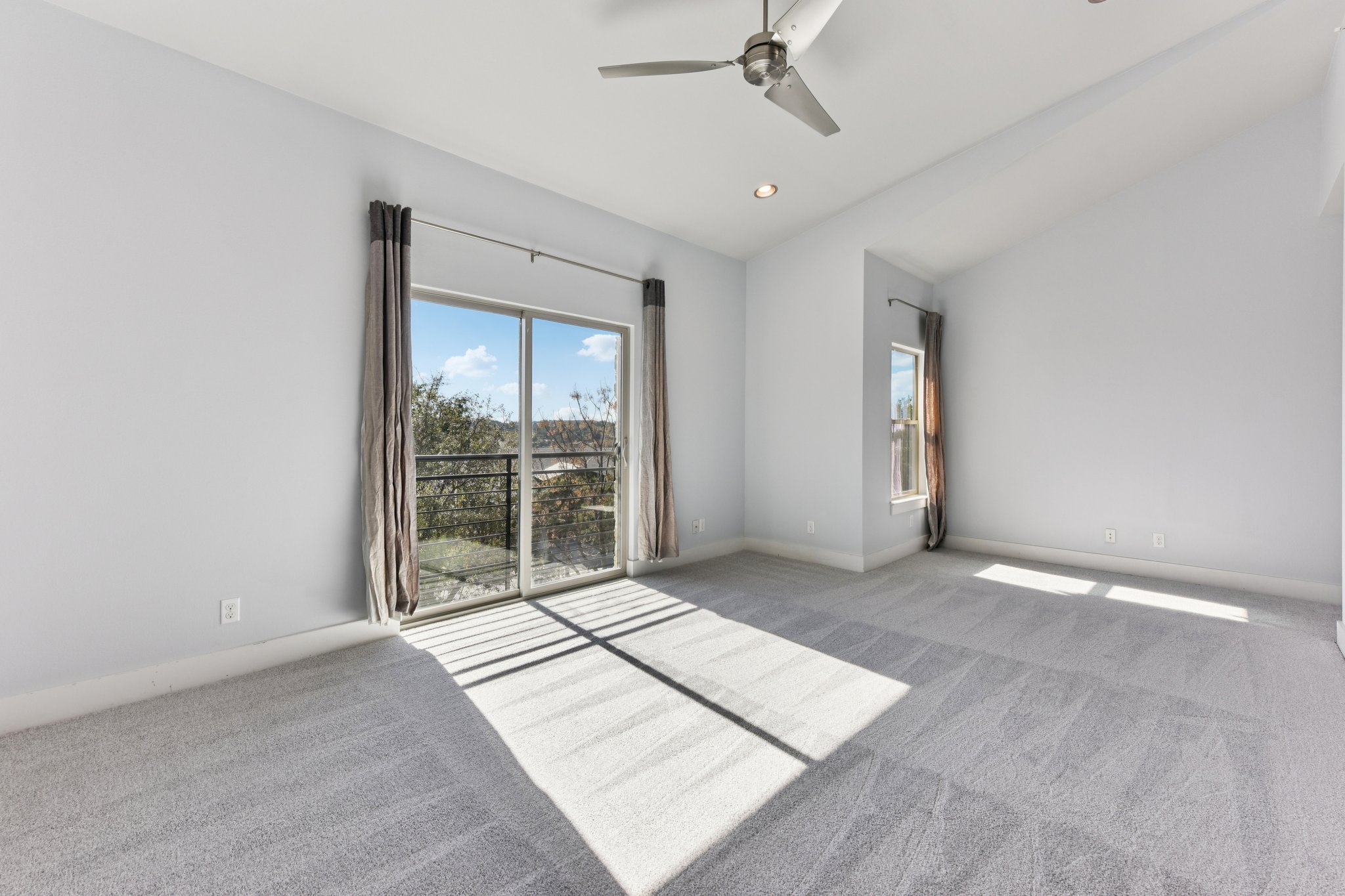 8110 Ranch Road 2222, Unit 98 Austin, TX 78730 - Photo 27 of 37 Carpeted spare room featuring vaulted ceiling, a ceiling fan, and recessed lighting