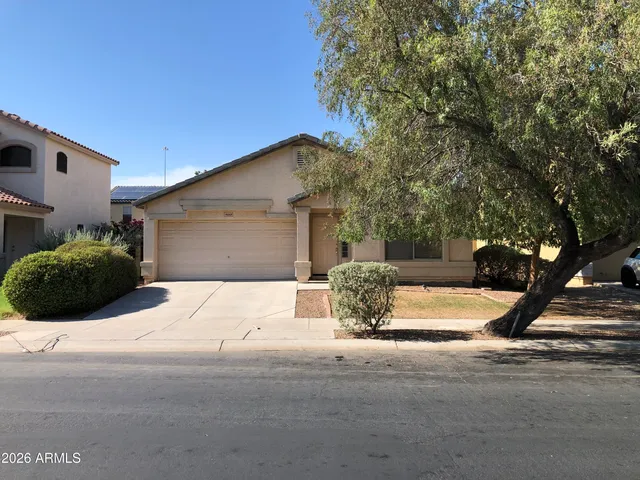a view of a house with a yard and garage