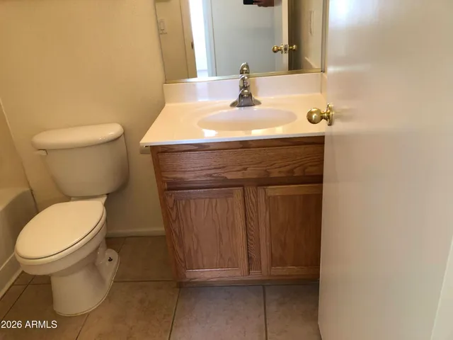a bathroom with a sink toilet and mirror