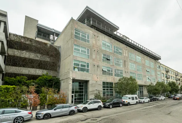 a couple of cars parked in front of a building