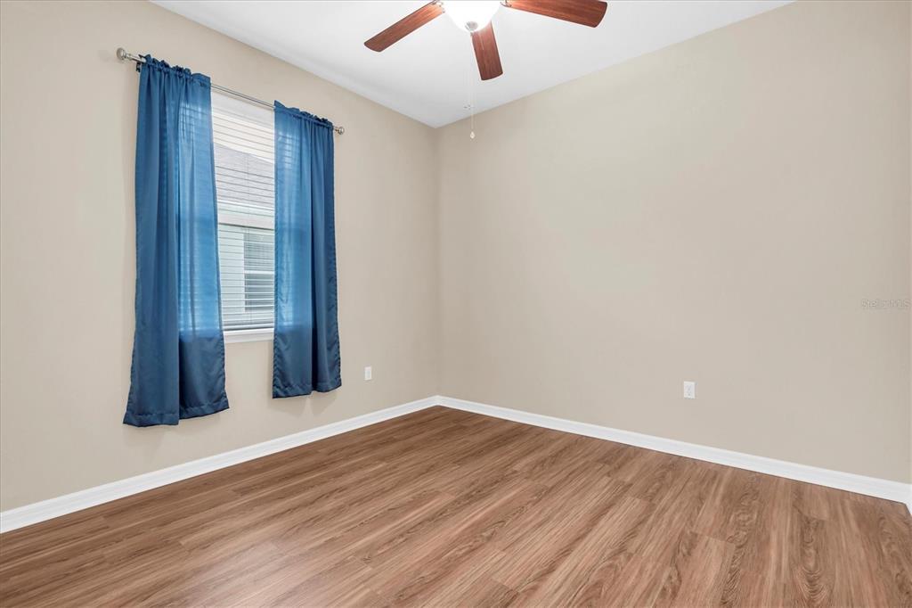 11236 Merganser Way New Port Richey, FL 34654 - Photo 14 of 41 wooden floor in an empty room with a window