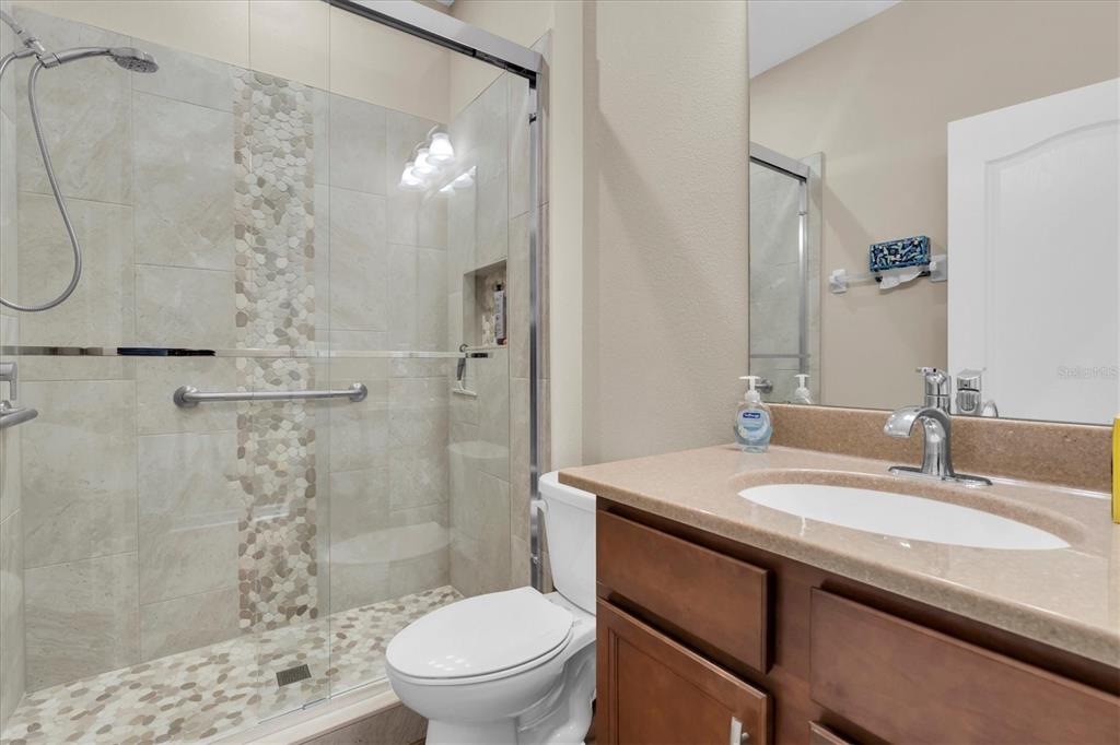 11236 Merganser Way New Port Richey, FL 34654 - Photo 16 of 41 a bathroom with a sink toilet vanity and shower