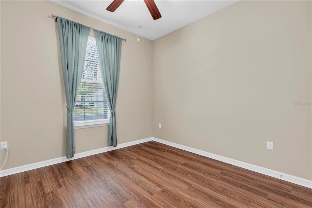 11236 Merganser Way New Port Richey, FL 34654 - Photo 17 of 41 an empty room with wooden floor and windows