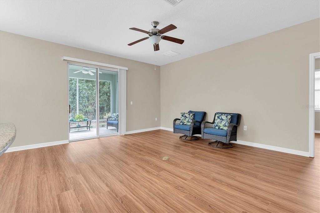 11236 Merganser Way New Port Richey, FL 34654 - Photo 4 of 41 a work room with wooden floor and a ceiling fan