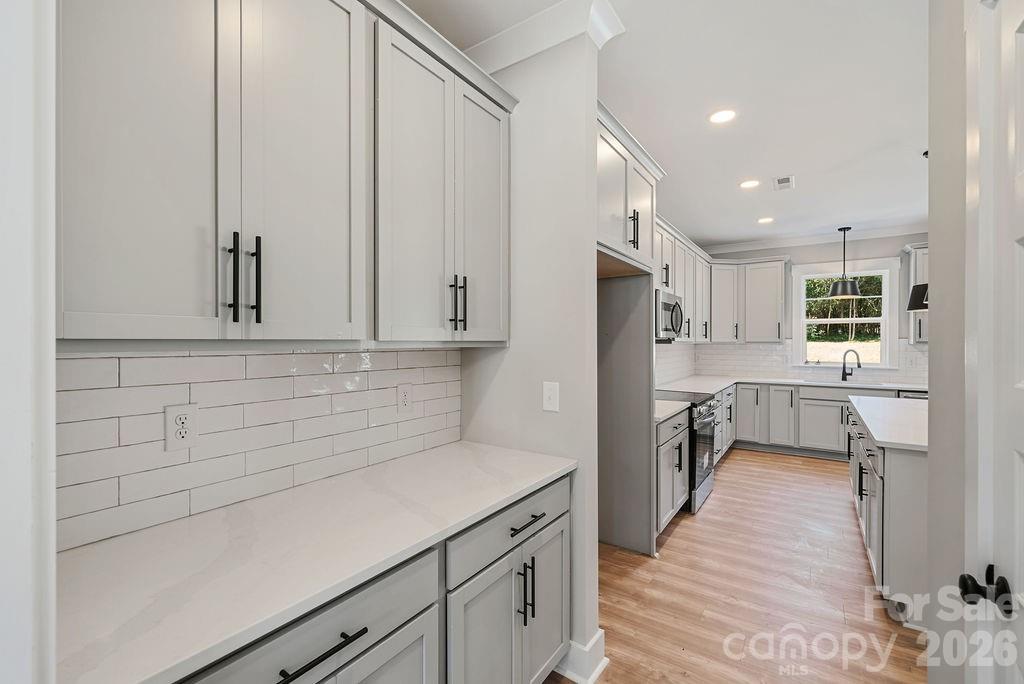 1024 Baylor Grove Road, Unit 19 Monroe, NC 28112 - Photo 23 of 47 a kitchen with a refrigerator and white cabinets