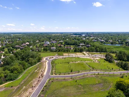 an aerial view of a house with swimming pool and lake view