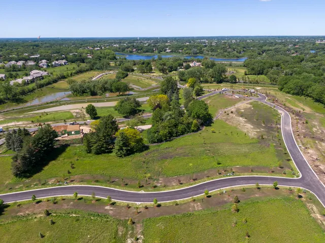 an aerial view of a house with garden space and lake view