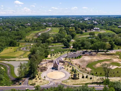 an aerial view of residential houses with outdoor space and river