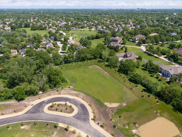 an aerial view of a residential houses with outdoor space and river
