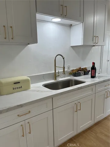 a kitchen with white cabinets