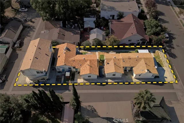 an aerial view of multiple houses with yard