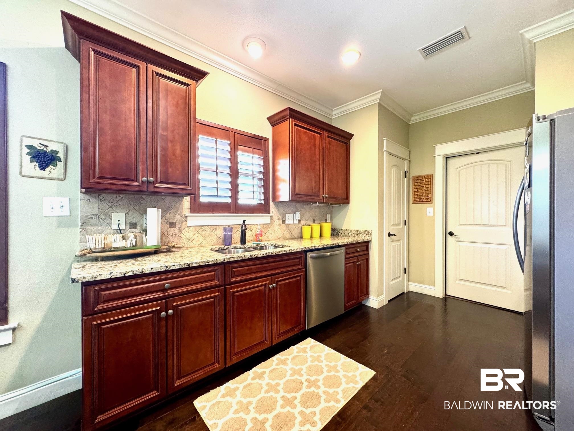 1030 Crown Walk Drive Foley, AL 36535 - Photo 10 of 40 Kitchen featuring a sink, dark brown cabinets, visible vents, and stainless steel appliances