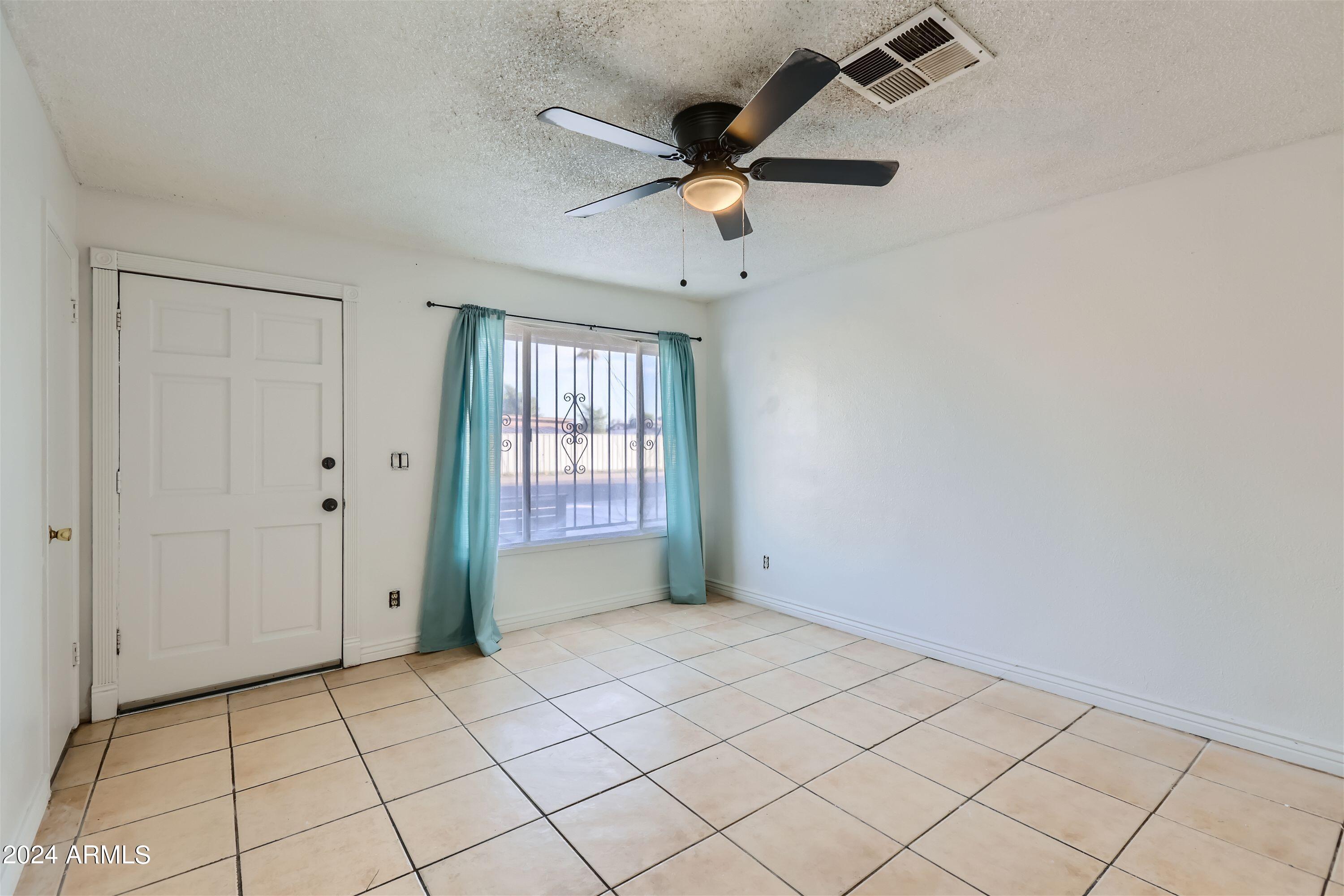 5202 West Berkeley Road Phoenix, AZ 85035 - Photo 3 of 12 a view of an empty room and window