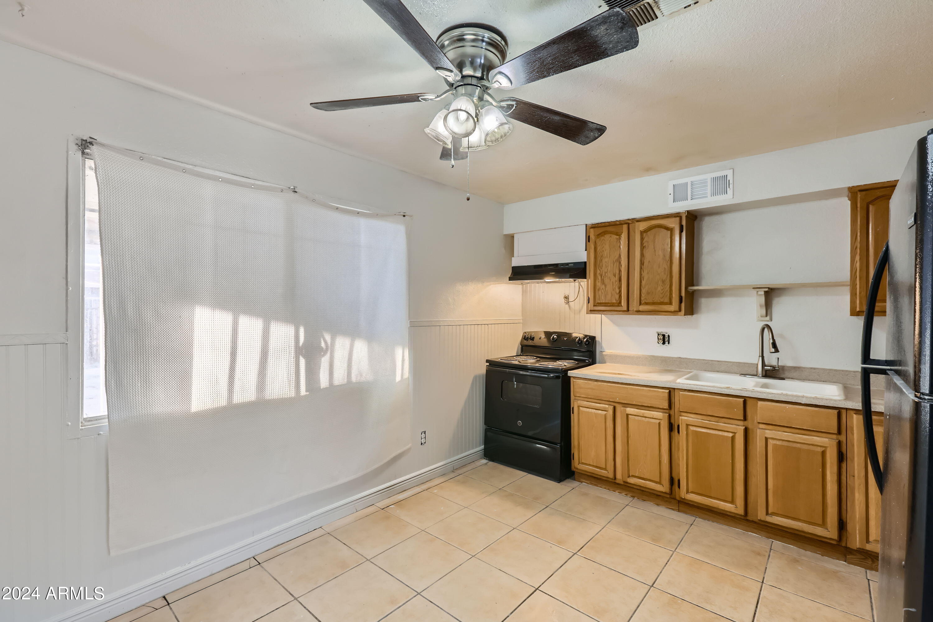 5202 West Berkeley Road Phoenix, AZ 85035 - Photo 6 of 12 a kitchen with a sink stainless steel appliances and cabinets