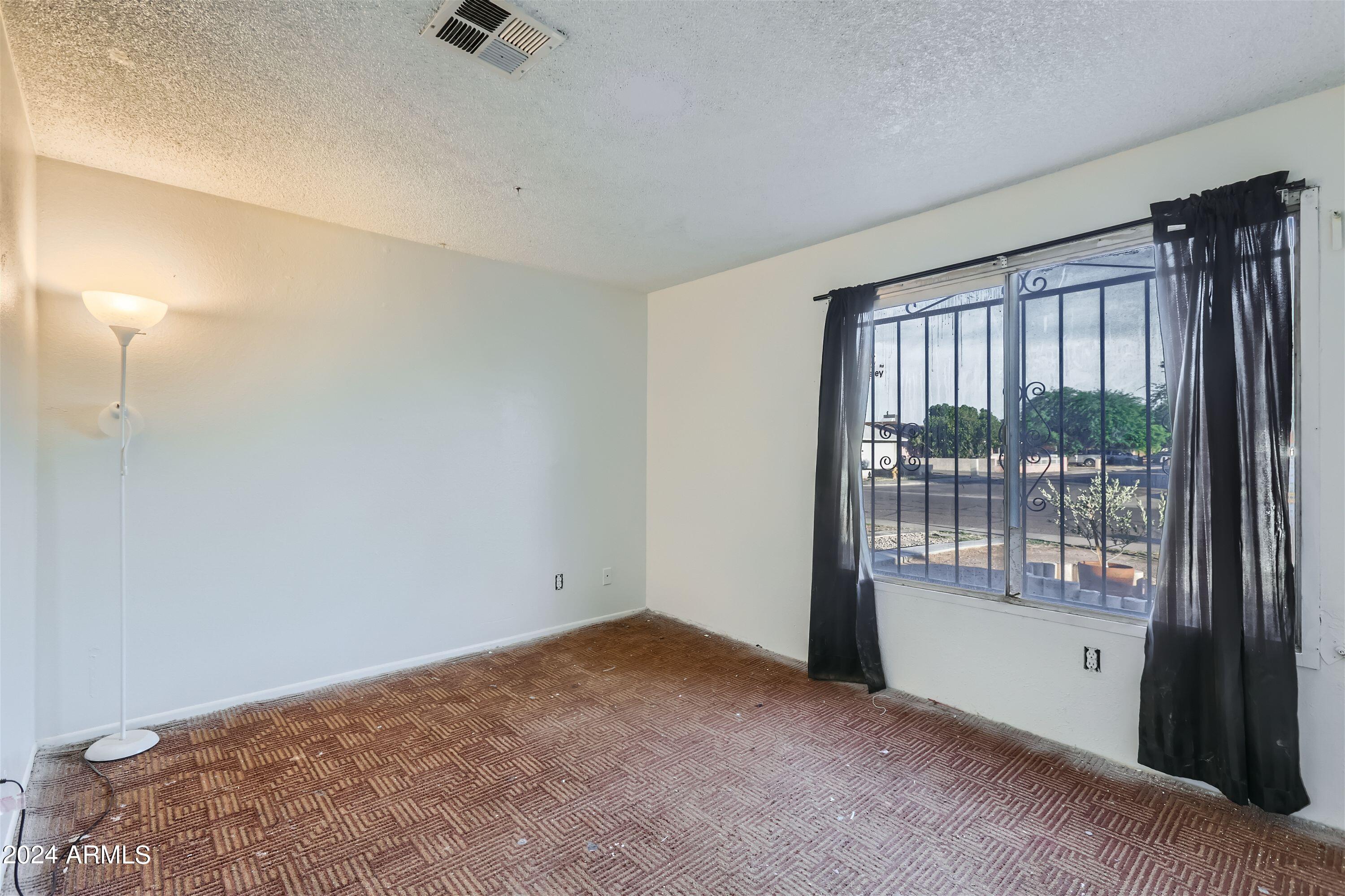 5202 West Berkeley Road Phoenix, AZ 85035 - Photo 8 of 12 a view of an empty room with a window
