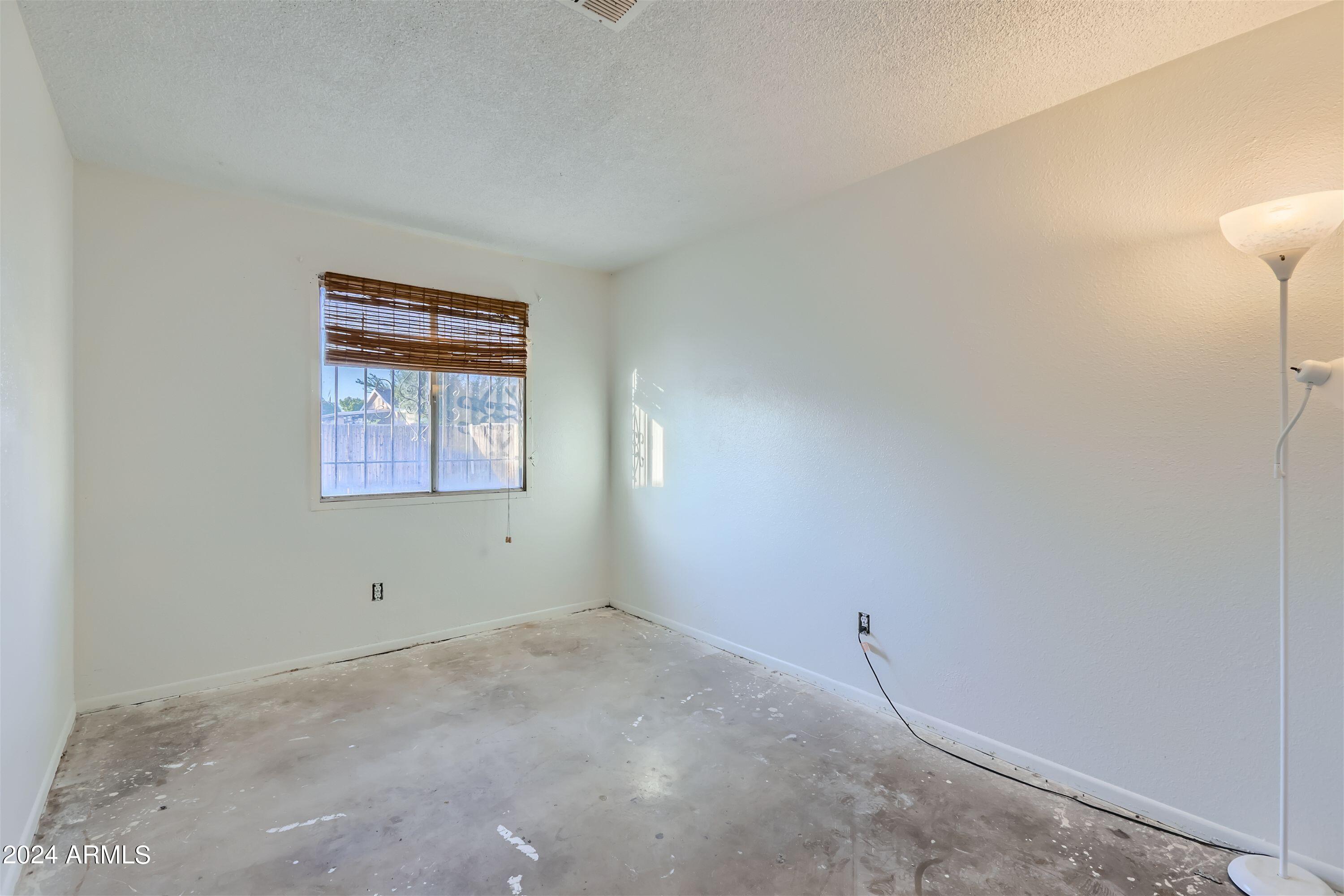 5202 West Berkeley Road Phoenix, AZ 85035 - Photo 9 of 12 an empty room with a window