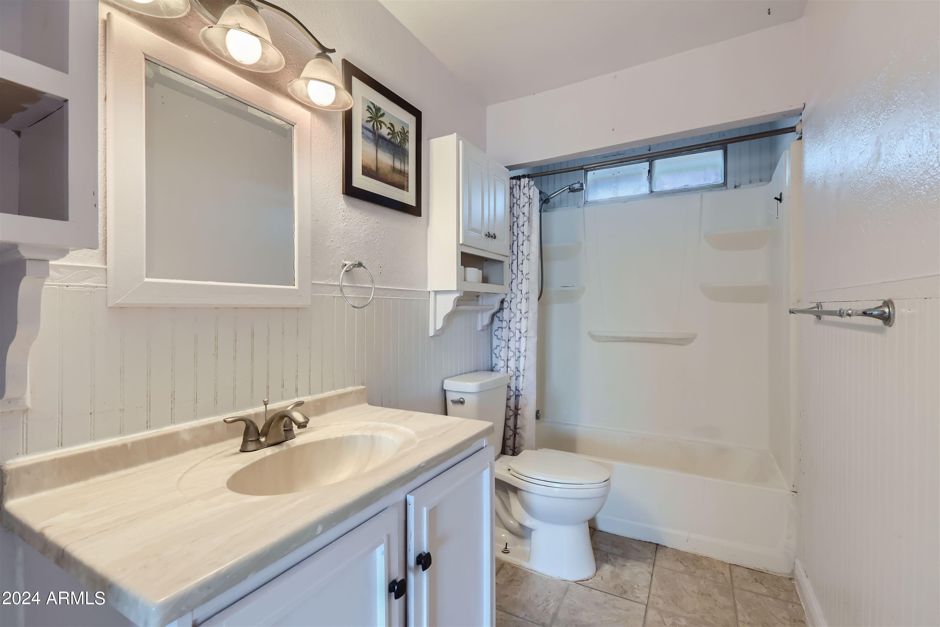 5202 West Berkeley Road Phoenix, AZ 85035 - Photo 10 of 12 a bathroom with a sink toilet and shower