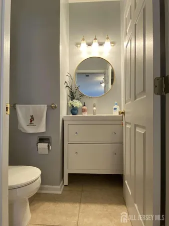 a bathroom with a sink a mirror and a toilet