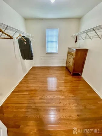 a view of a room with wooden floor and window
