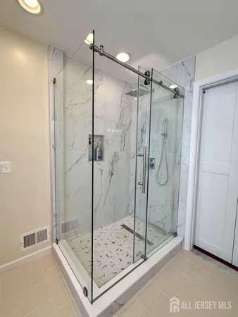 a bathroom with a shower and a sink