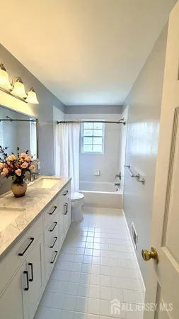 a bathroom with a tub sink and mirror