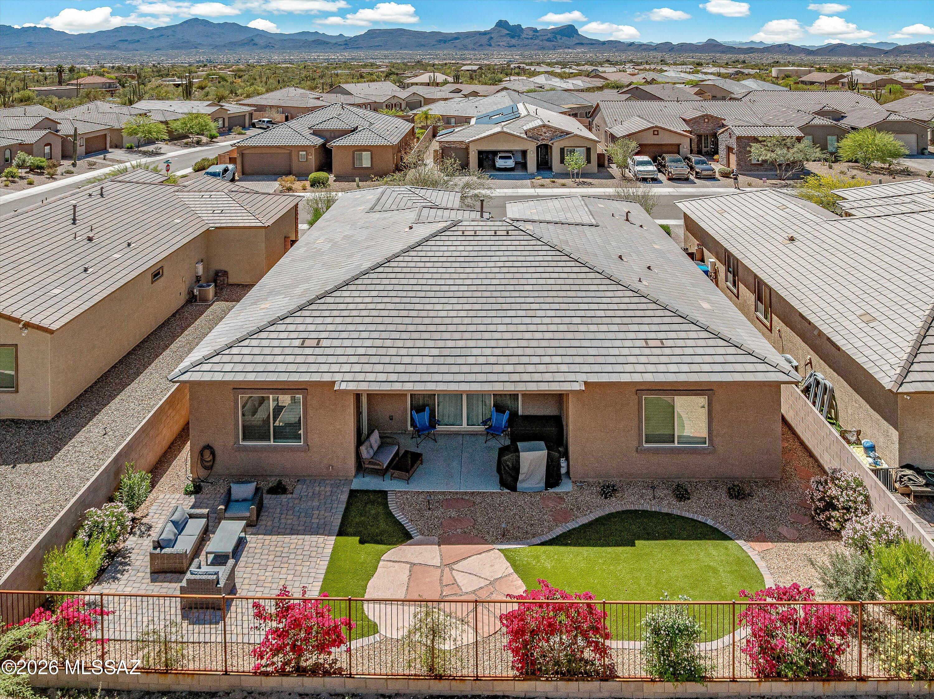 5196 West Ridgemont Court Tucson, AZ 85742 - Photo 17 of 46 Backyard featuring a combination of flagstone, brick pavers, view fencing, and turf