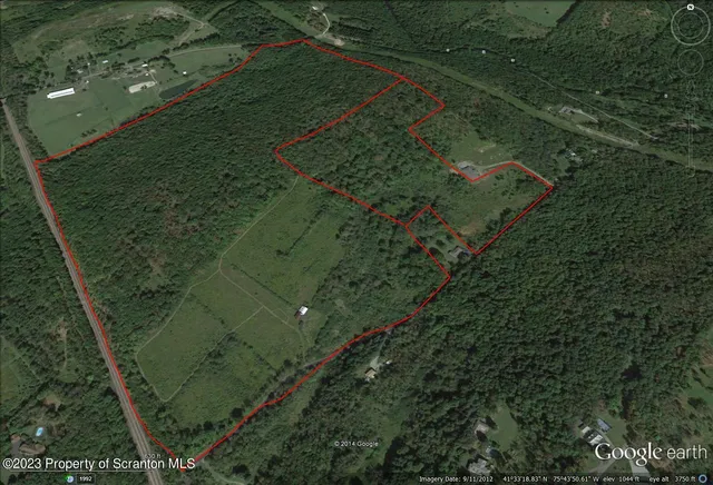 an aerial view of a residential houses with outdoor space