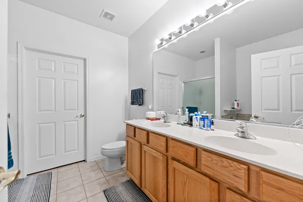 a spacious bathroom with a double vanity sink and a mirror