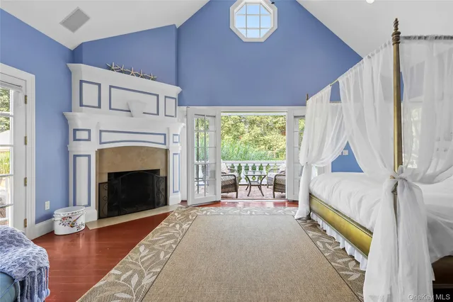 a bedroom with a bed and a fireplace