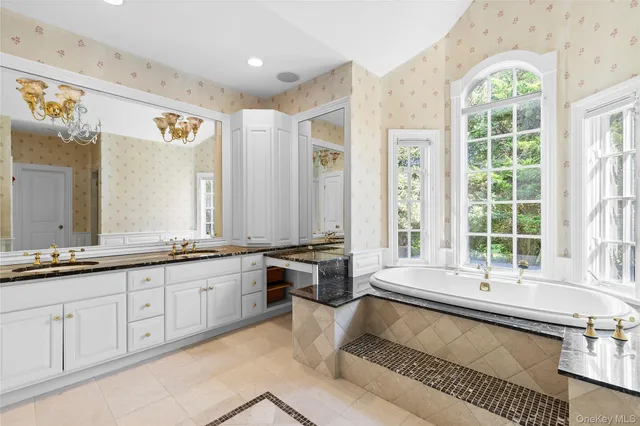 a large white kitchen with a large window