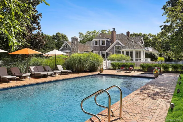 a view of swimming pool with outdoor seating and plants