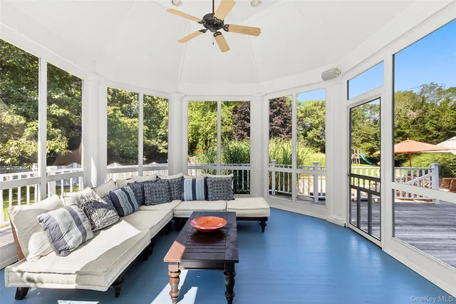 a living room with furniture and a floor to ceiling window