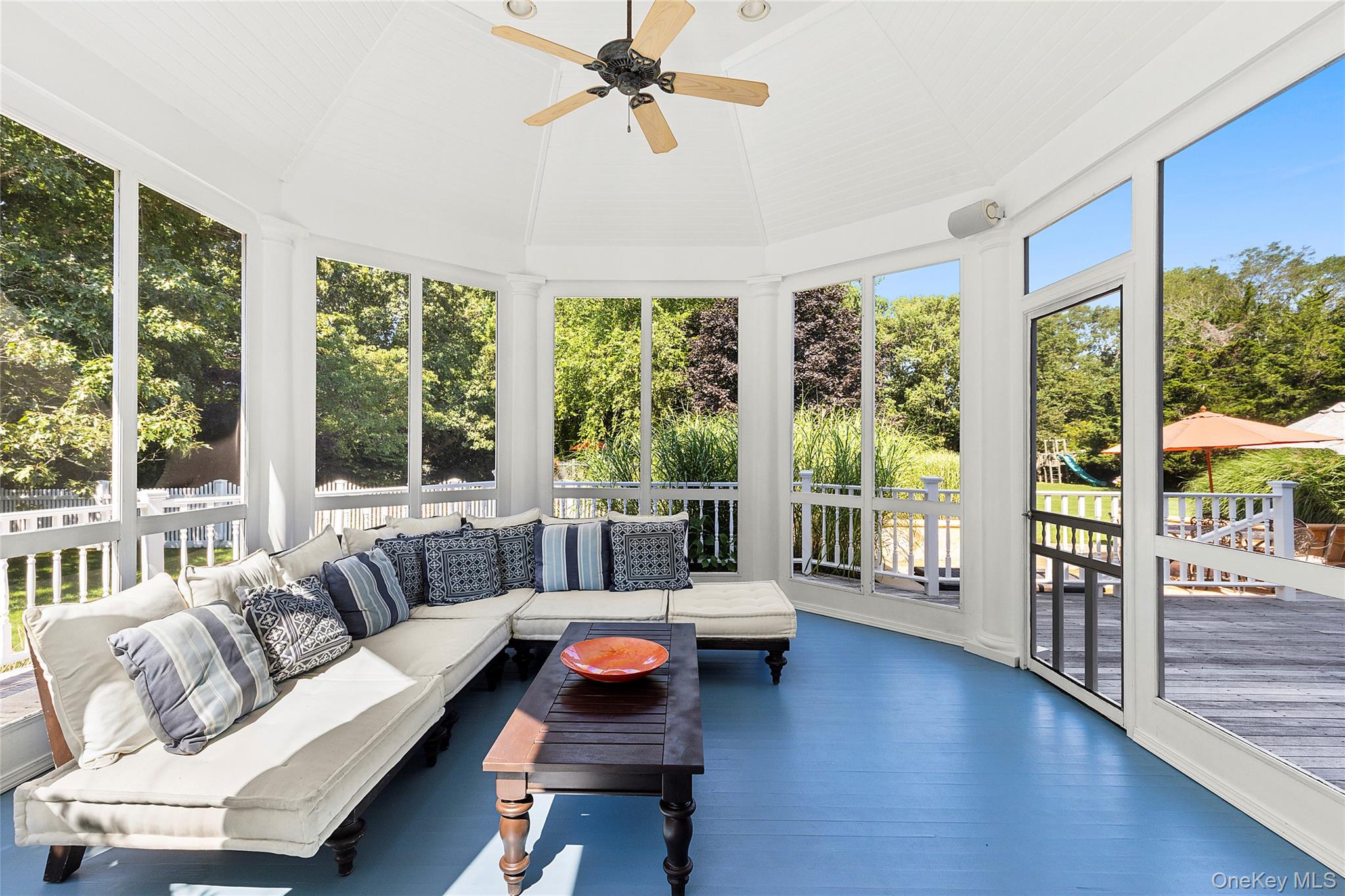 29 Cedar Lane Remsenburg, NY 11960 - Photo 22 of 27 a living room with furniture and a floor to ceiling window