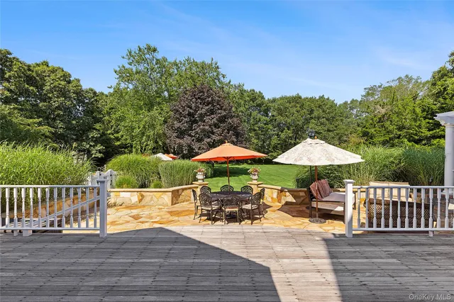 a view of a patio with furniture and a yard