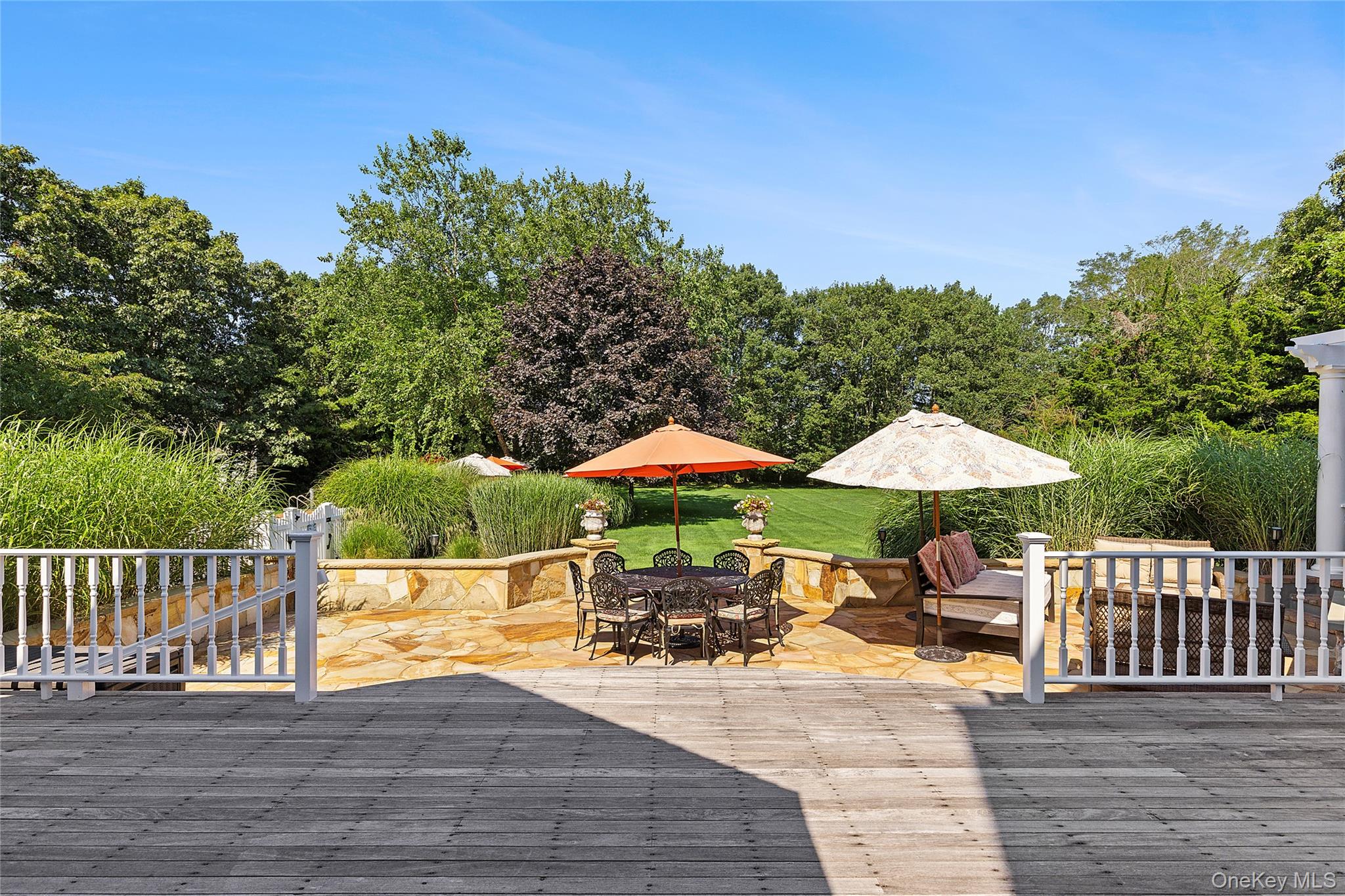 29 Cedar Lane Remsenburg, NY 11960 - Photo 23 of 27 a view of a patio with furniture and a yard