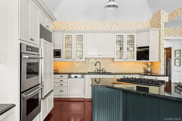 a kitchen with stainless steel appliances a sink stove and refrigerator