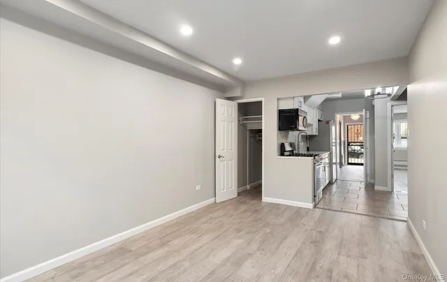a view of a kitchen with a refrigerator and a microwave
