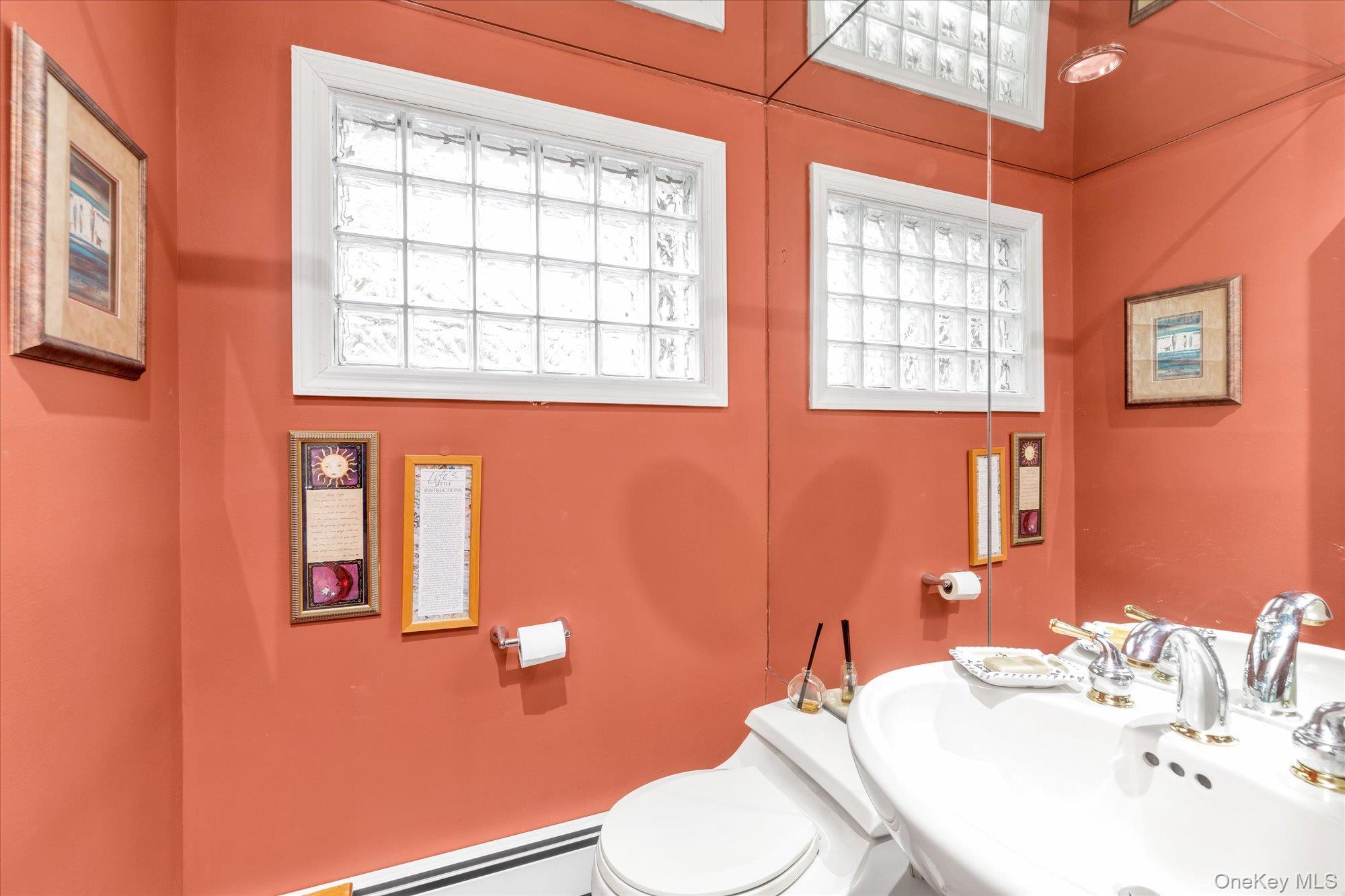 1055 Cedarhurst Street Valley Stream, NY 11581 - Photo 13 of 27 a bathroom with a sink a toilet and mirror