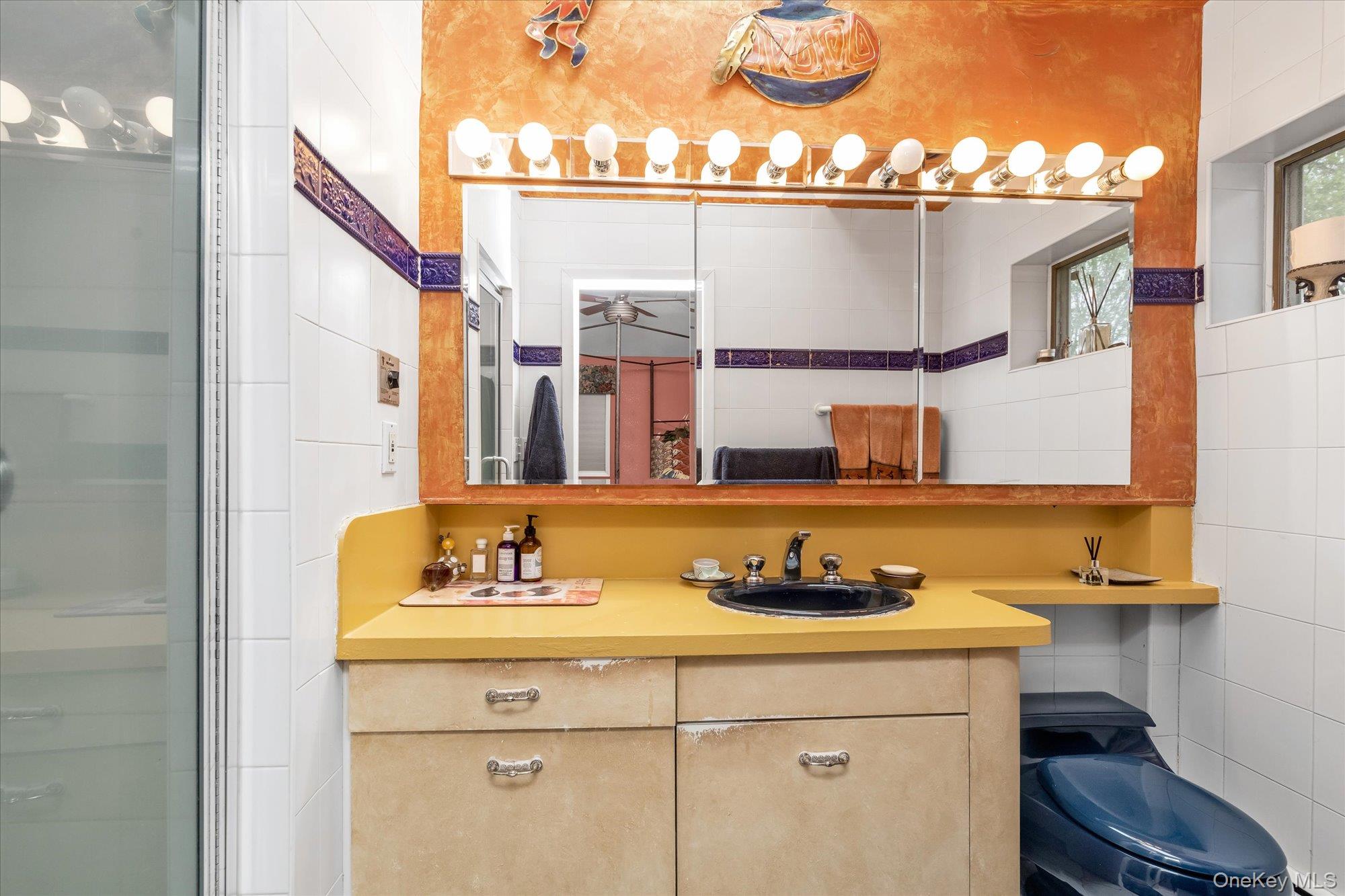 1055 Cedarhurst Street Valley Stream, NY 11581 - Photo 15 of 27 a bathroom with a sink and a mirror