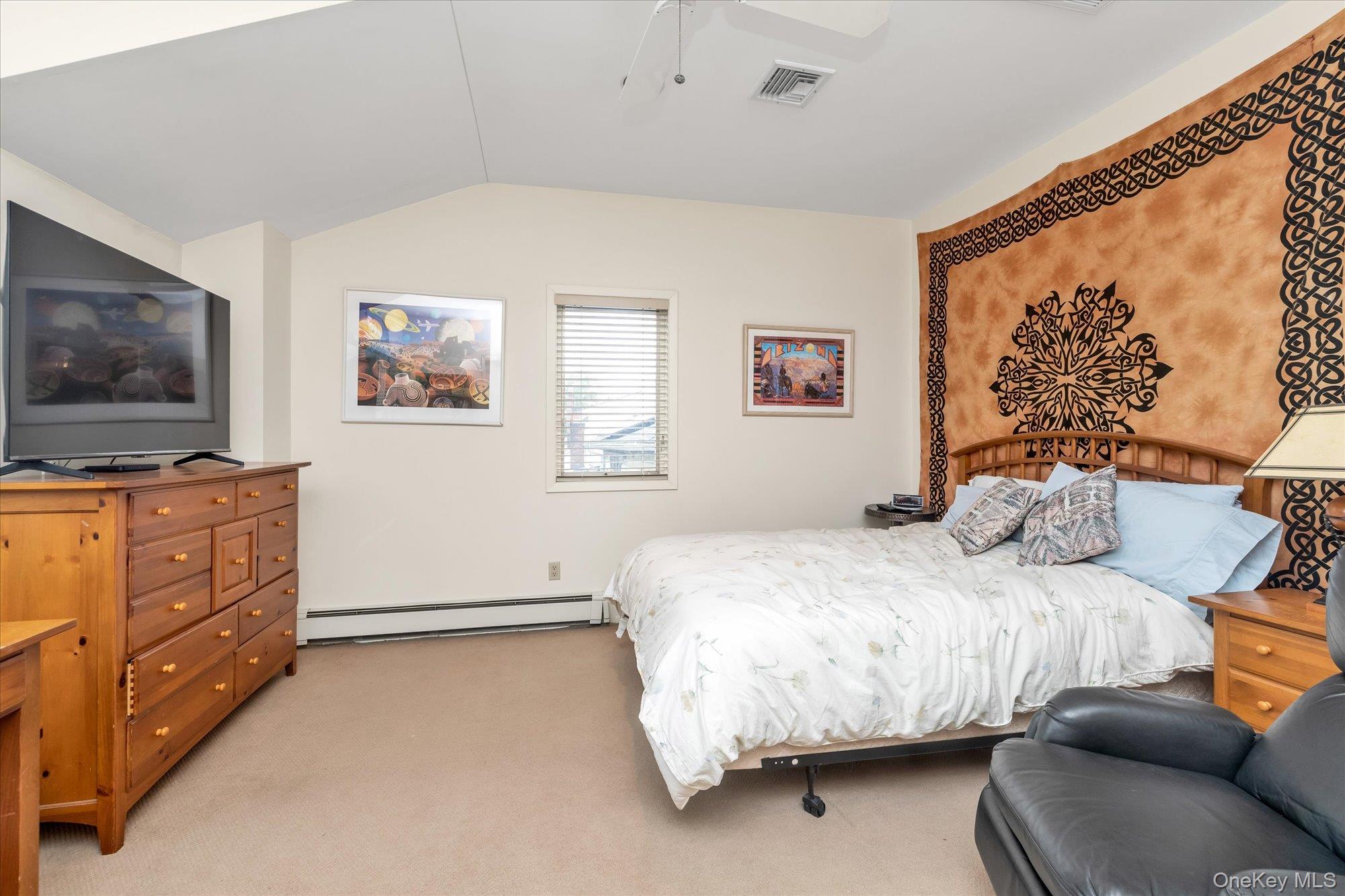 1055 Cedarhurst Street Valley Stream, NY 11581 - Photo 18 of 27 a bedroom with a bed and a flat screen tv