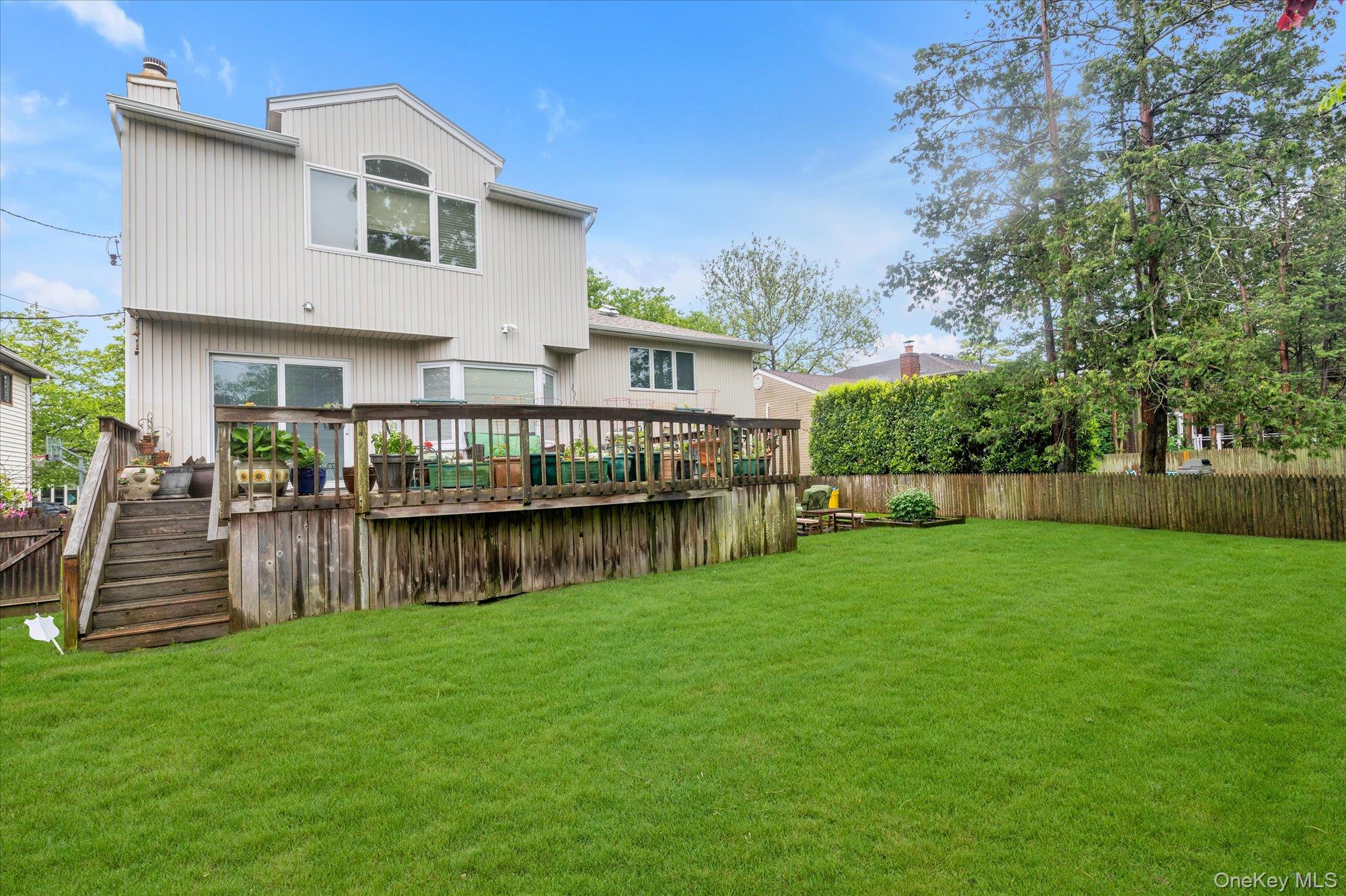 1055 Cedarhurst Street Valley Stream, NY 11581 - Photo 26 of 27 a view of a house with a yard