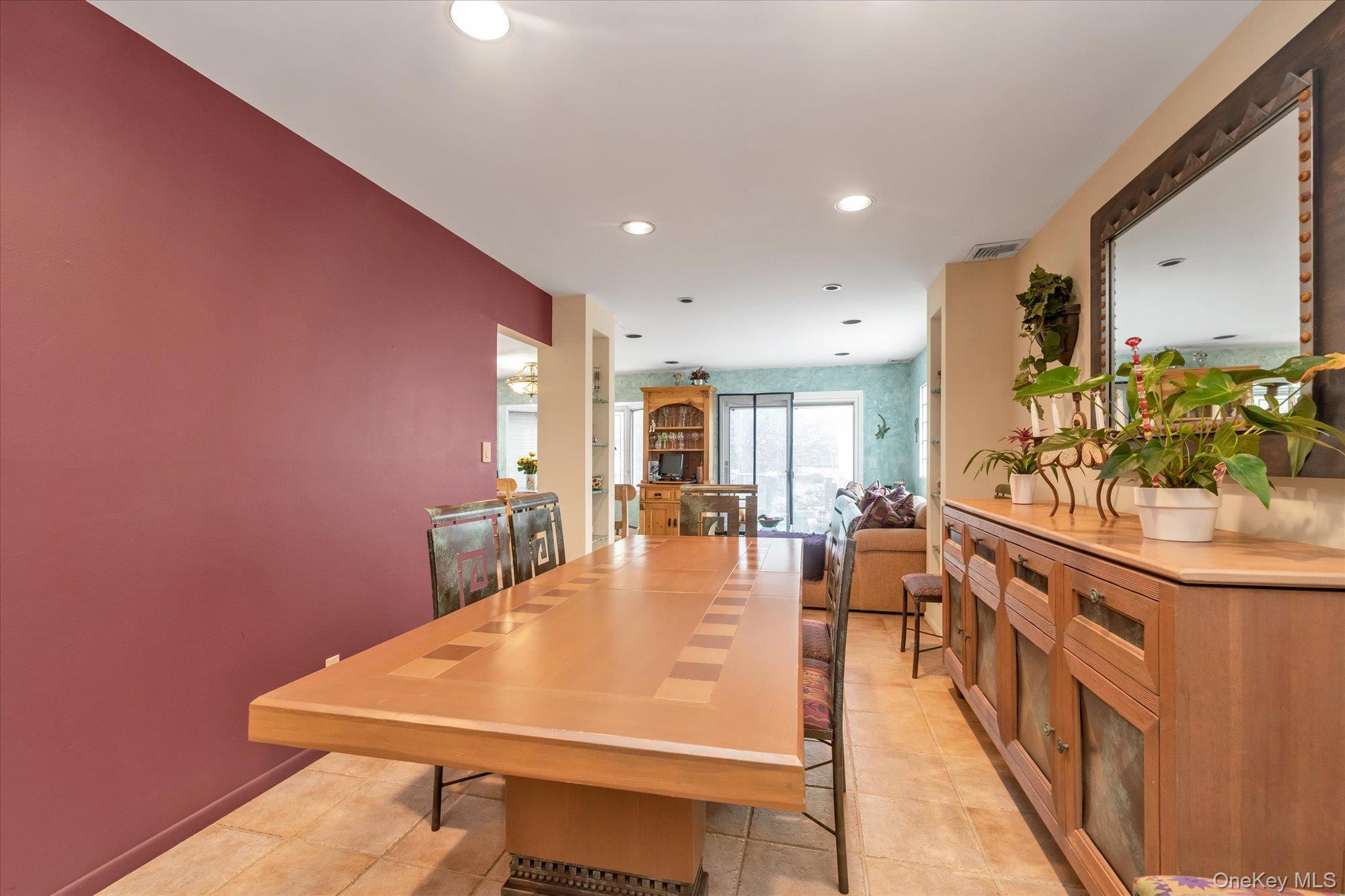 1055 Cedarhurst Street Valley Stream, NY 11581 - Photo 5 of 27 a large dining hall with stainless steel appliances a dining table and chairs with wooden floor